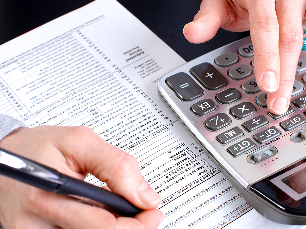Man working on calculator