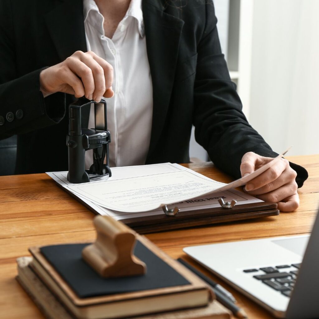female notary stamping a document